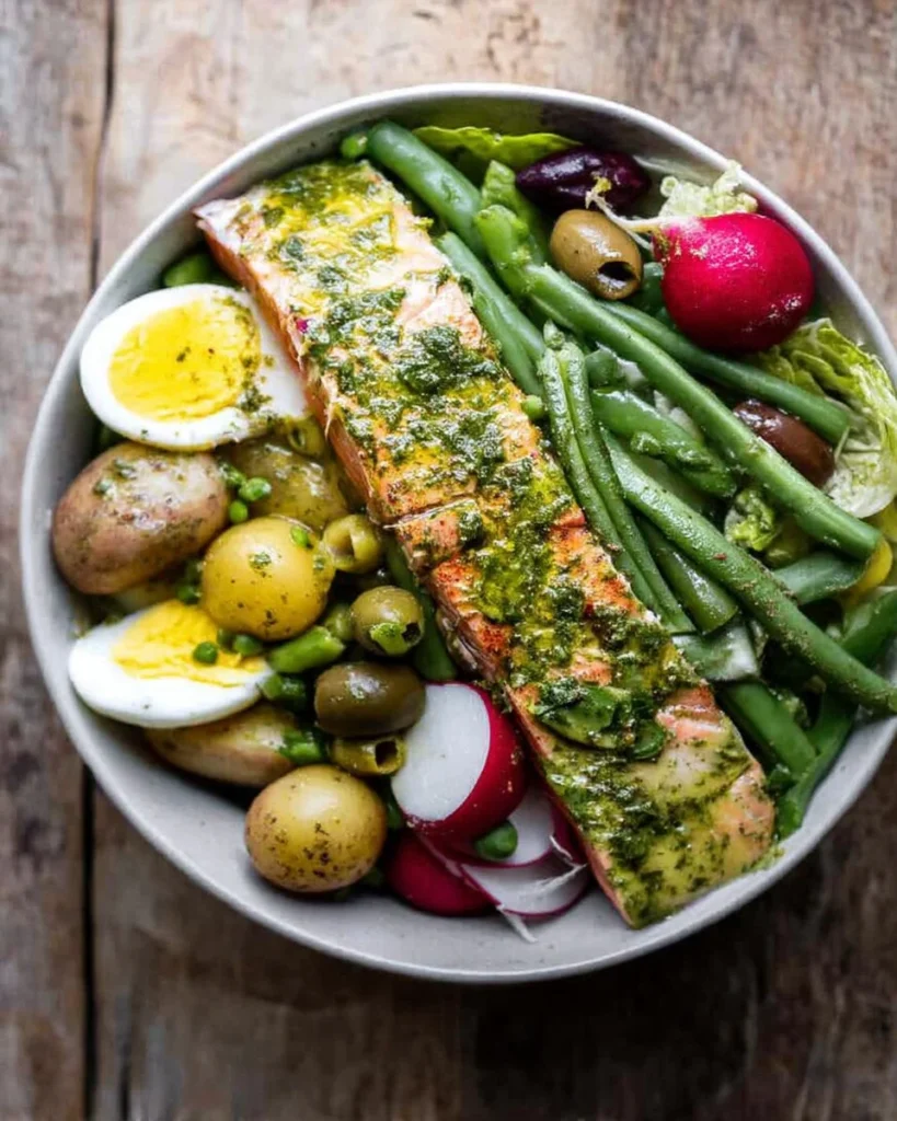 Delicious plate of Salmon Niçoise salad with fresh vegetables and olives