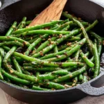 Skillet green beans sautéed with garlic and spices for a flavorful dish.