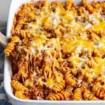 Delicious Sloppy Joe Casserole served on a plate with toppings.