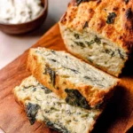 Slices of delicious Spinach and Feta No-Yeast Bread on a wooden board.