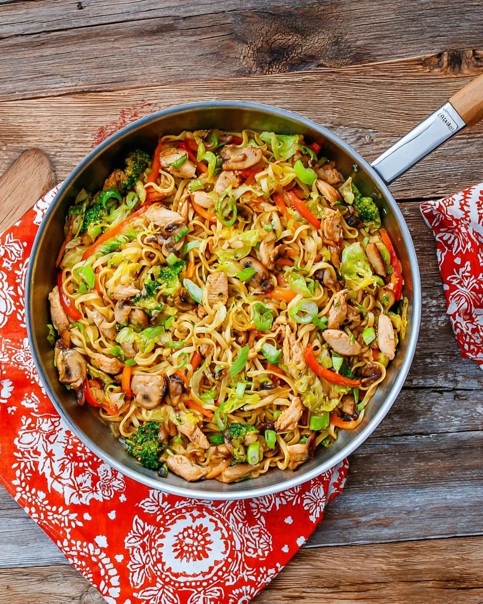 Stir fry noodles with chicken and vegetables served in a bowl
