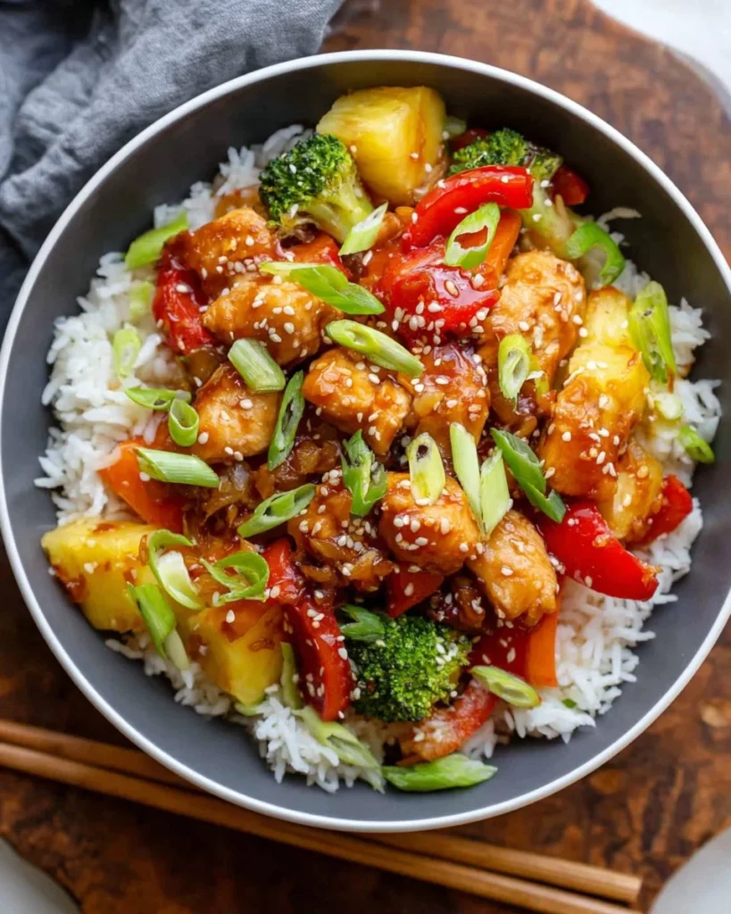 Sweet and sour chicken bowls with colorful vegetables and rice for a tasty midweek dinner