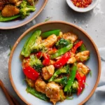 Delicious Szechuan Chicken served with vibrant vegetables and spicy sauce.