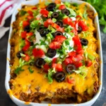 Delicious Taco Casserole topped with cheese and fresh ingredients.