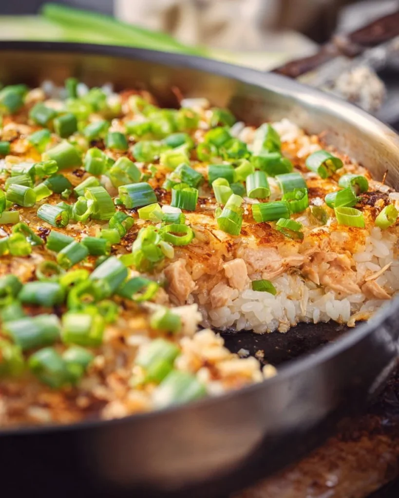 Delicious salmon sushi bake served in a casserole dish with garnishes.