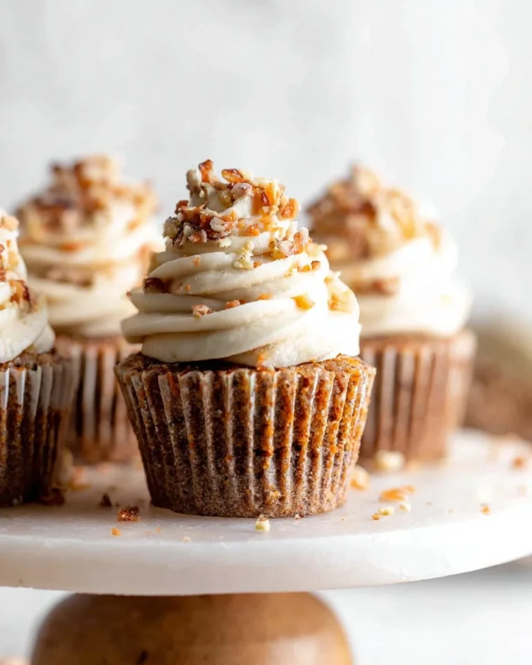 Delicious vegan carrot cupcakes with vegan frosting on a white plate