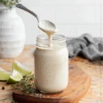 Homemade Vegan Ranch Dressing in a bowl with fresh herbs