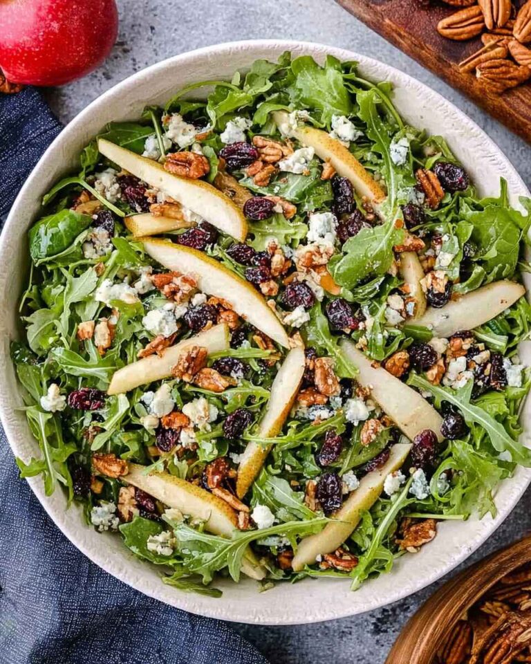 Freshly prepared Arugula Pear Salad with fruits and nuts