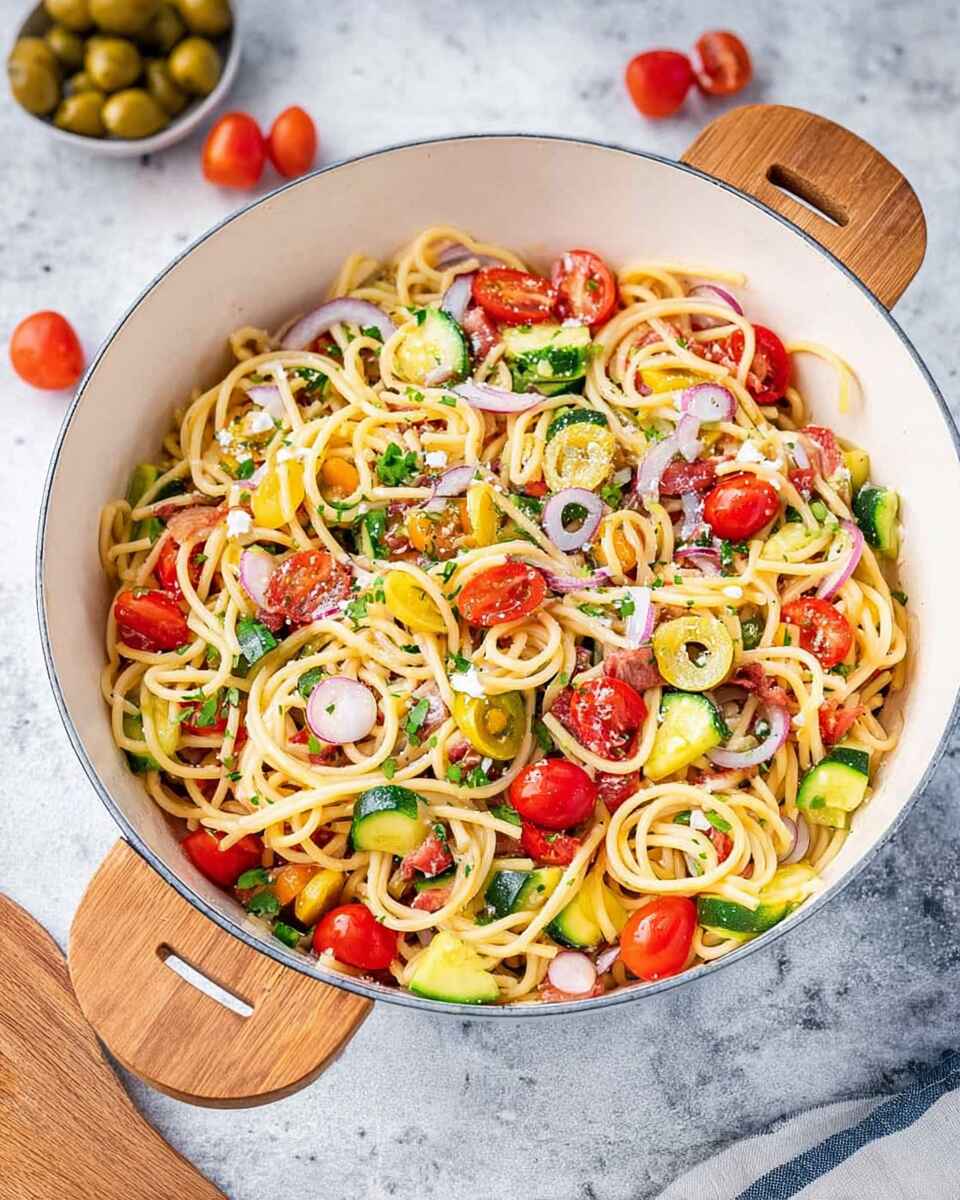 Delicious cold spaghetti salad with fresh vegetables and dressing