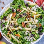 Freshly prepared Arugula Pear Salad with fruits and nuts