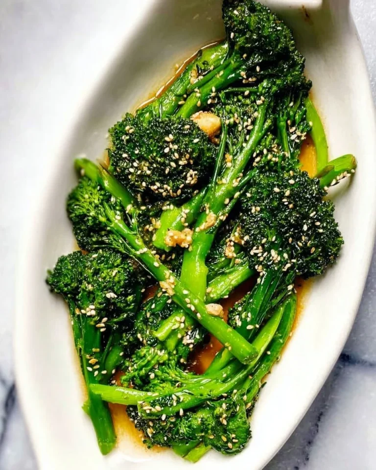 Plate of Asian Broccolini with sesame seeds and ginger garnish