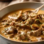 Plate of rich and creamy Beef Stroganoff served over egg noodles