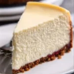 Delicious classic cheesecake slice on a plate with fresh berries