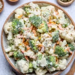 Colorful Broccoli Cauliflower Salad with dressing and toppings