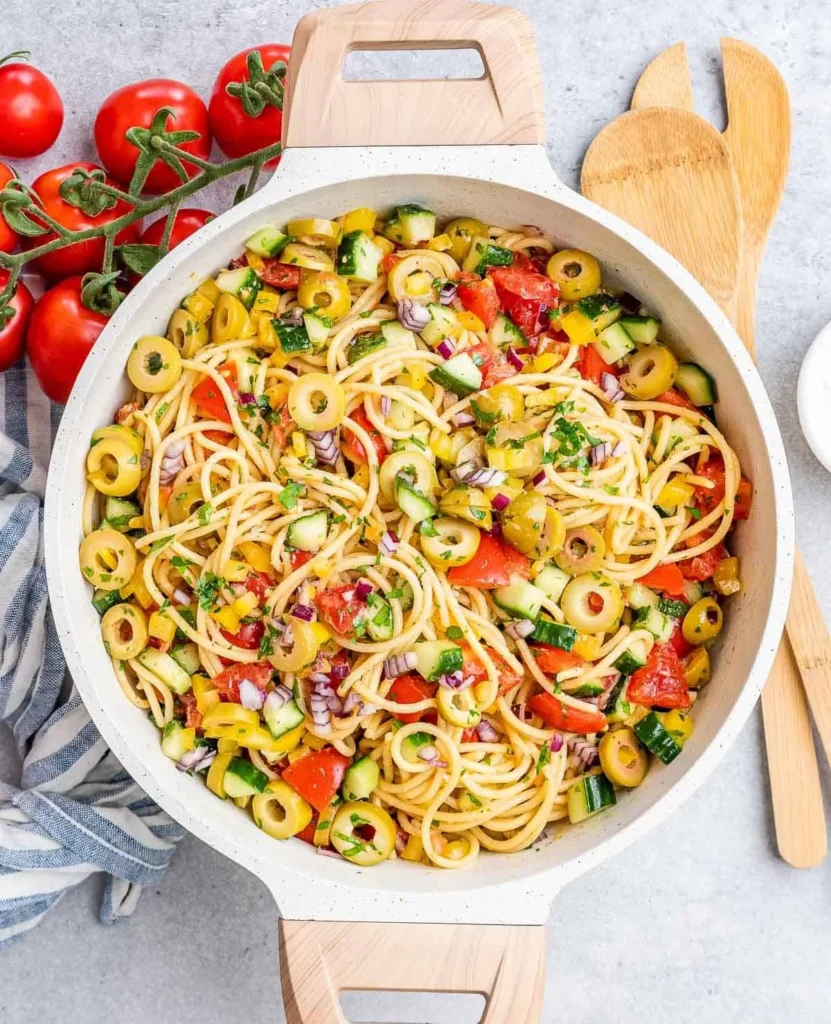Delicious cold spaghetti salad with fresh vegetables and dressing