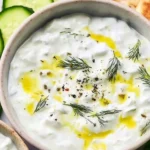 Bowl of easy authentic tzatziki with fresh cucumbers and herbs