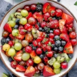 A colorful bowl of easy fruit salad made with fresh fruits
