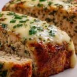Delicious Garlic Parmesan Chicken Meatloaf served with a side of vegetables.