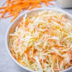 Bowl of homemade coleslaw salad with fresh cabbage and dressing