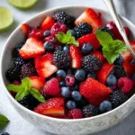 Colorful mixed berry fruit salad with strawberries, blueberries, and raspberries