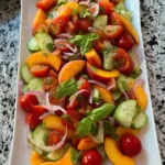 Colorful Peach Tomato Cucumber Salad with fresh herbs and dressing