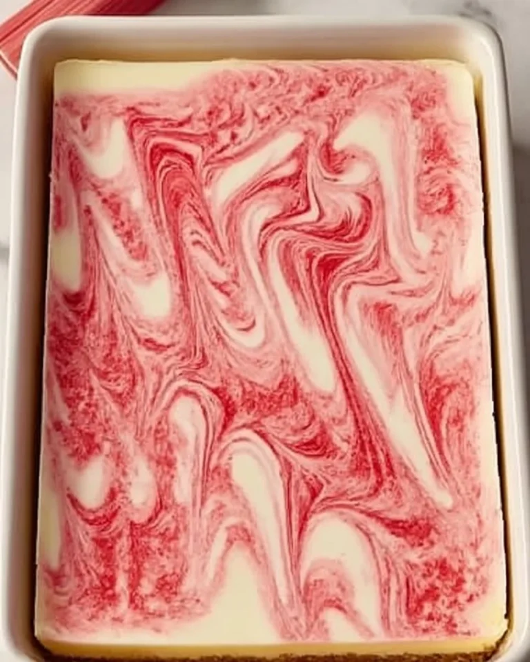 Delicious homemade rhubarb cheesecake on a white plate