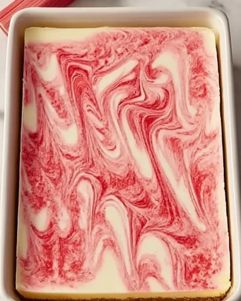 Delicious homemade rhubarb cheesecake on a white plate