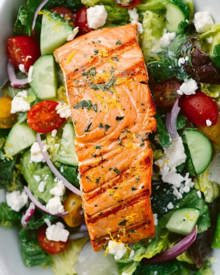 Fresh Salmon Greek Salad topped with Lemon Basil Dressing
