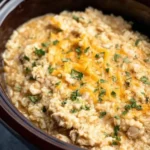 Delicious slow-cooker chicken and rice served in a bowl, garnished with herbs.