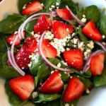 Fresh Spinach Strawberry Feta Salad with colorful ingredients in a bowl