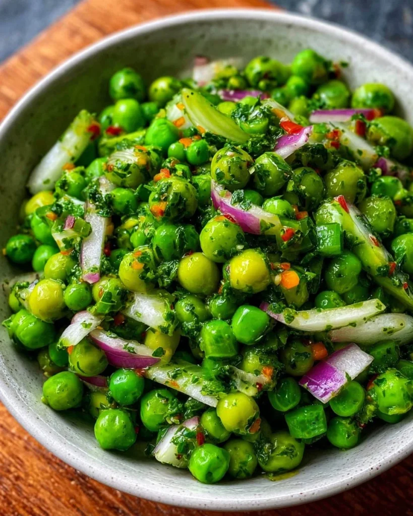 A colorful spring pea salad with fresh ingredients in a bowl.