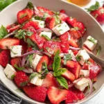 Fresh Strawberry Feta Salad with greens, sliced strawberries, and feta cheese