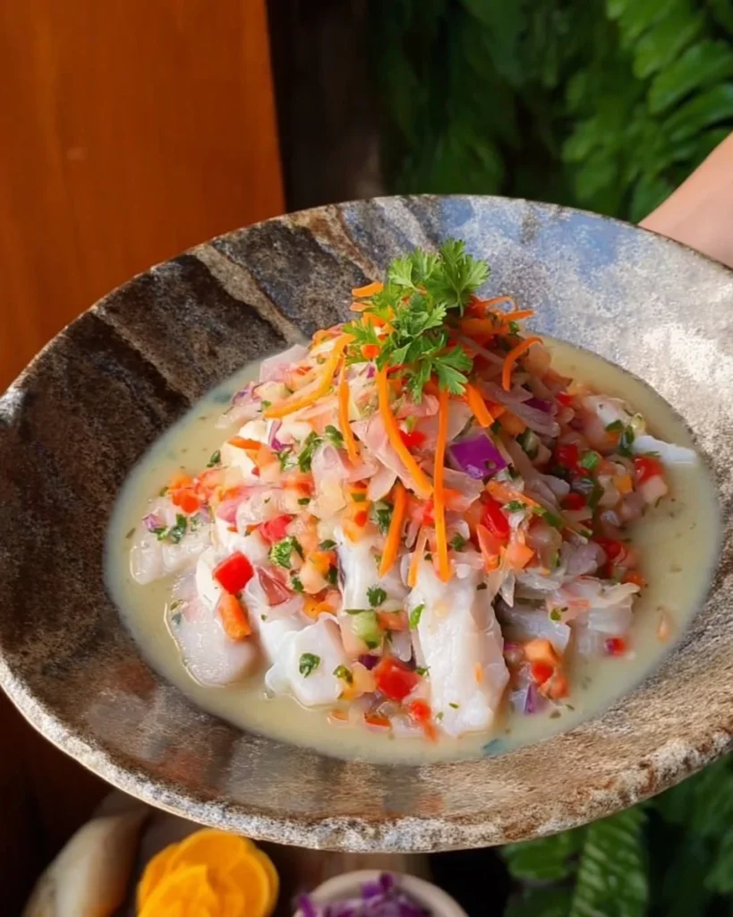 A plate of delicious Tilapia Ceviche garnished with lime and cilantro.