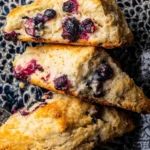 Freshly baked blueberry scones on a wooden table