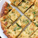 Cheesy Keto garlic bread topped with herbs and melted cheese