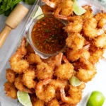 Delicious coconut shrimp served with sweet chili sauce on a plate