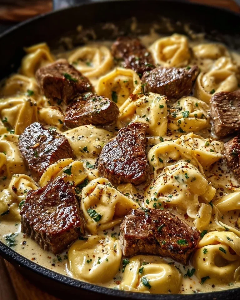 Cracked garlic steak tortellini in creamy sauce served on a plate