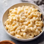 Delicious Crockpot Mac and Cheese in a bowl, topped with breadcrumbs.
