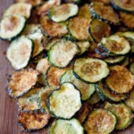 Tray of easy baked zucchini chips seasoned and ready to eat
