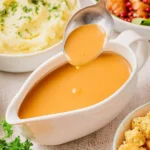 Easy chicken broth gravy recipe served over roasted chicken and mashed potatoes.