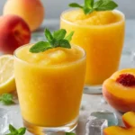 Refreshing Frozen Peach Lemonade served in a glass with ice and a peach slice