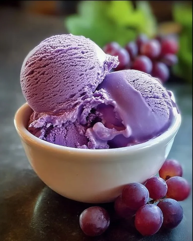 Delicious grape juice ice cream in a bowl with fresh grapes