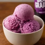 Homemade Grapico Ice Cream in a bowl topped with cherries and sprinkles