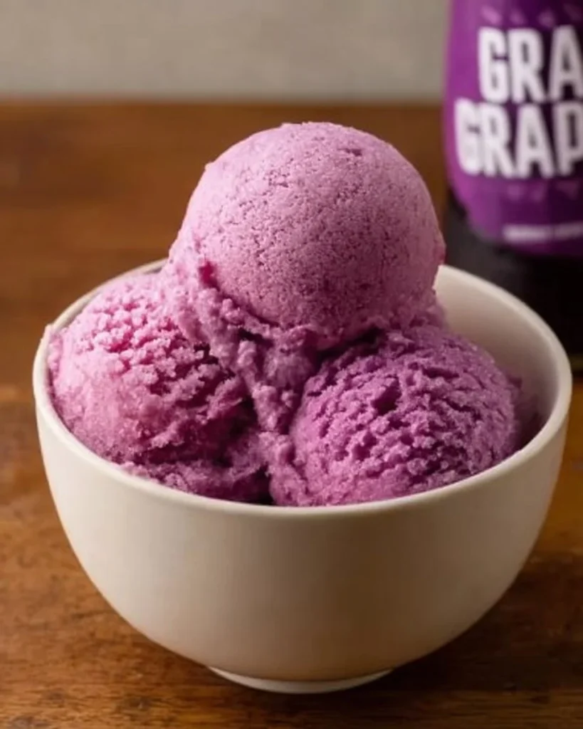 Homemade Grapico Ice Cream in a bowl topped with cherries and sprinkles