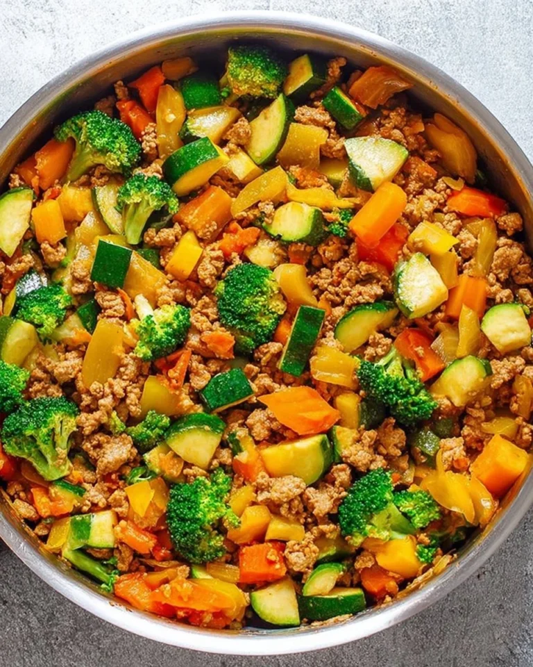 Healthy ground turkey stir fry with colorful vegetables in a skillet