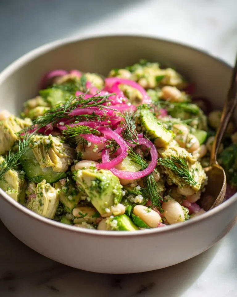Herby avocado white bean salad garnished with fresh herbs