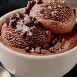 Bowl of high protein chocolate cottage cheese ice cream topped with chocolate shavings