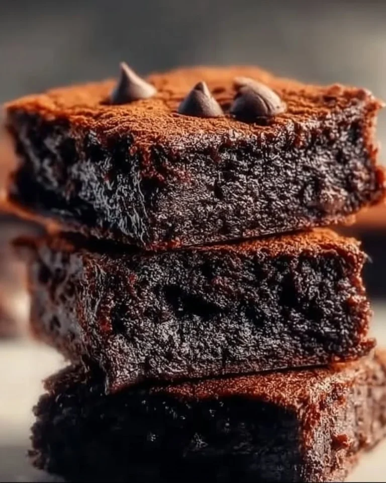 High-protein cottage cheese brownies on a plate with chocolate drizzle.