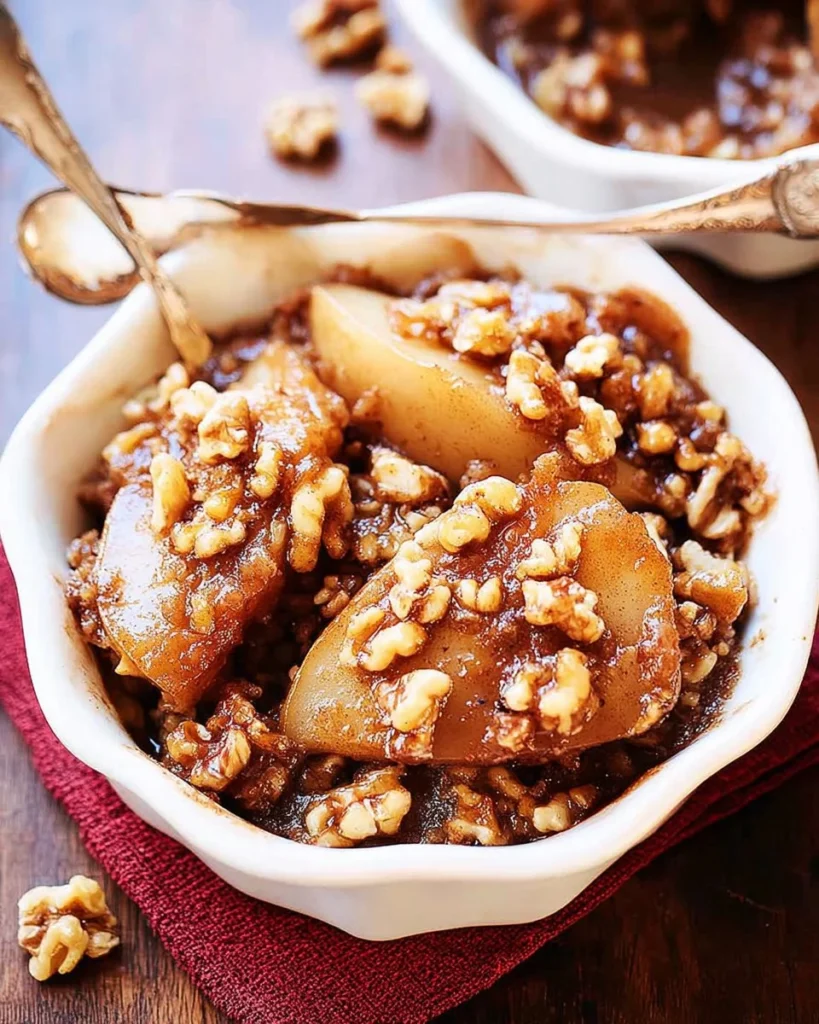 Keto Apple Crisp with Walnuts served in a bowl topped with cream