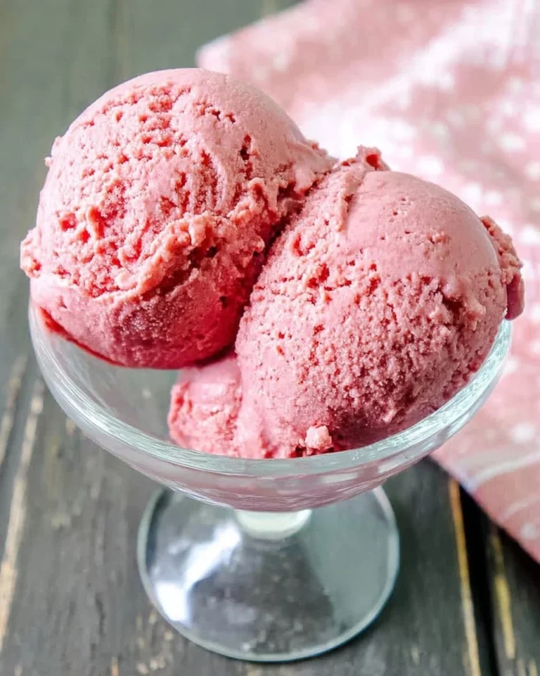 Delicious Keto Strawberry Ice Cream served in a bowl with fresh strawberries